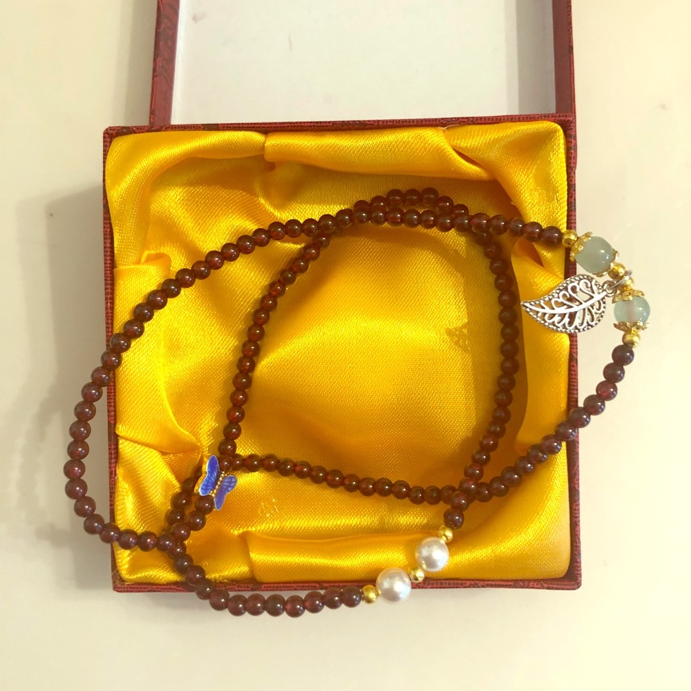 Red beaded necklace with charms